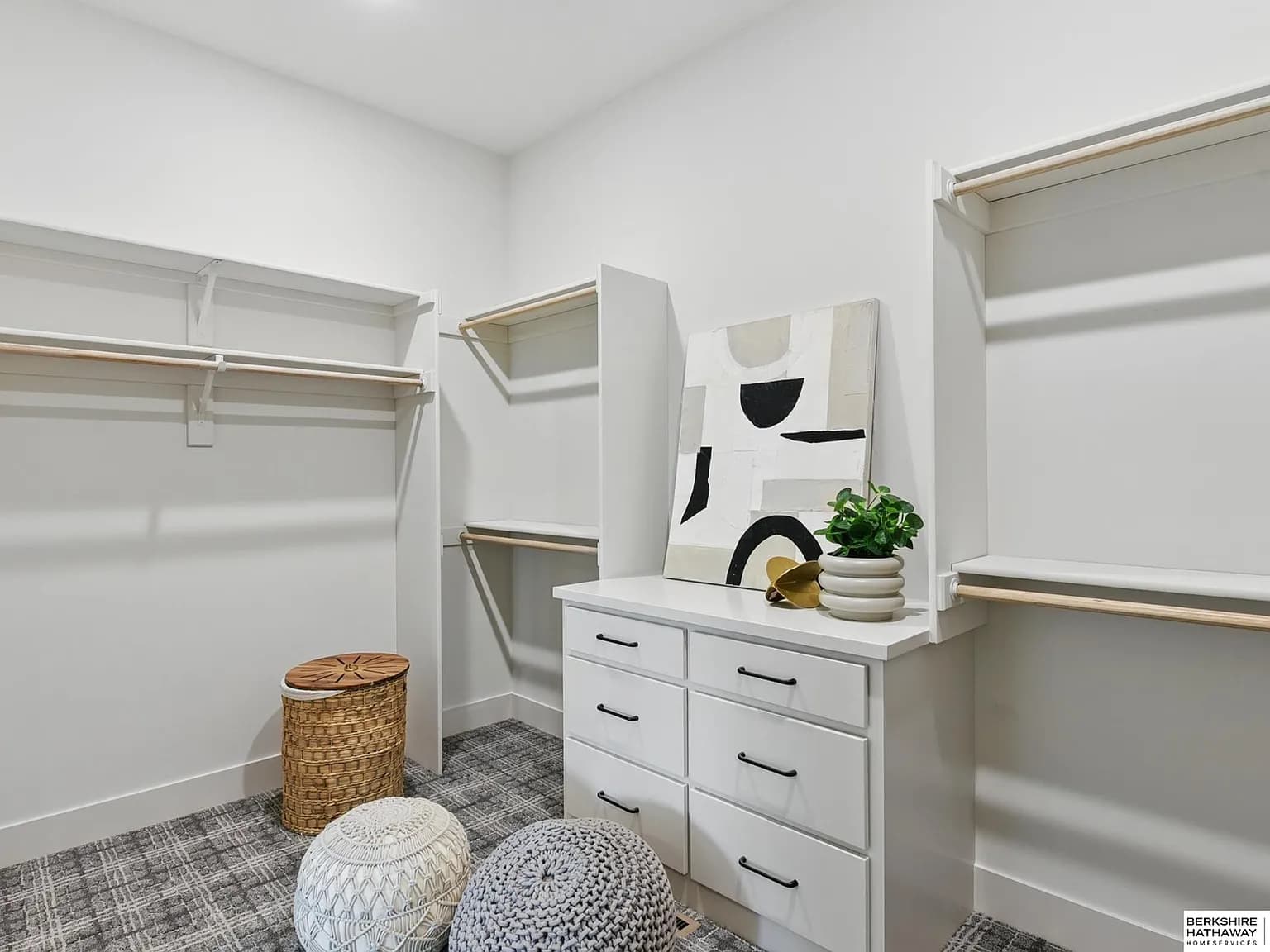 Custom walk-in closet with built-in shelving, drawers, and rods