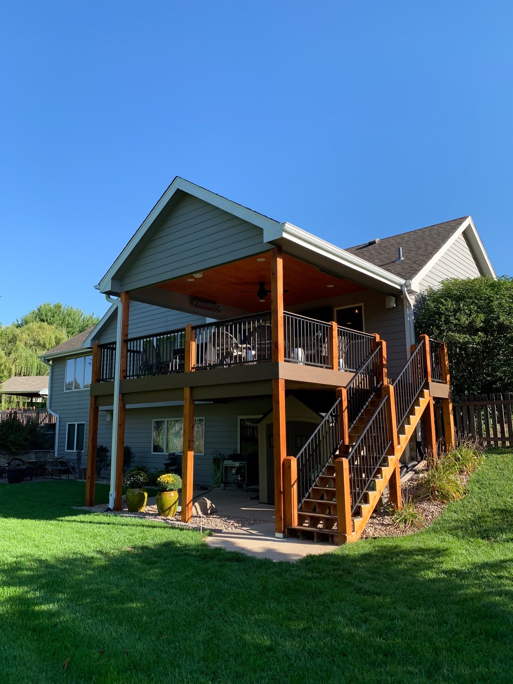 Two-story covered deck with staircase down to the backyard