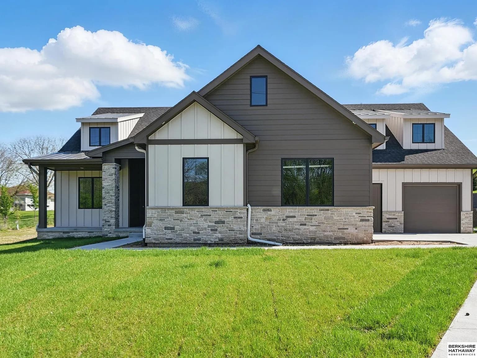 Craftsman-style custom home exterior with stone accents and covered front porch
